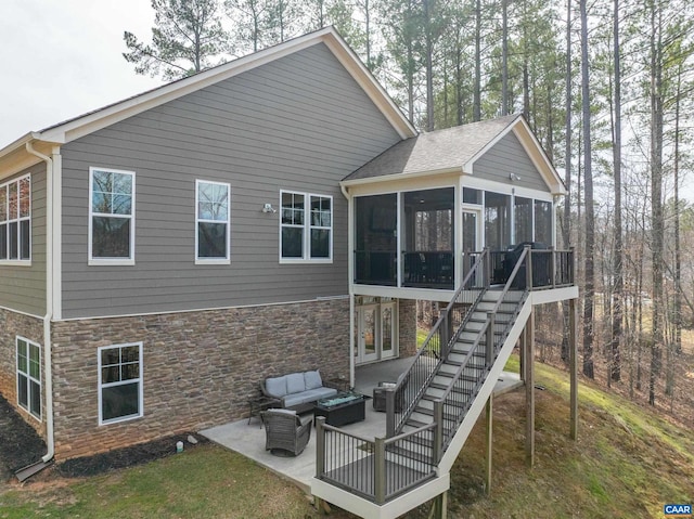 back of property featuring an outdoor living space, stairs, a sunroom, a patio area, and stone siding