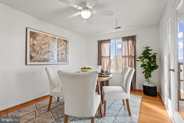 dining room with visible vents, baseboards, light wood-type flooring, and ceiling fan