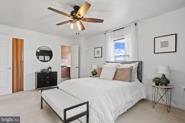 bedroom featuring light carpet, ceiling fan, and baseboards