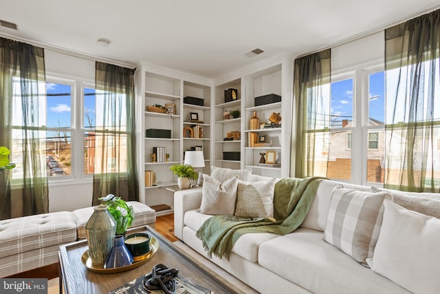 living room featuring visible vents and wood finished floors