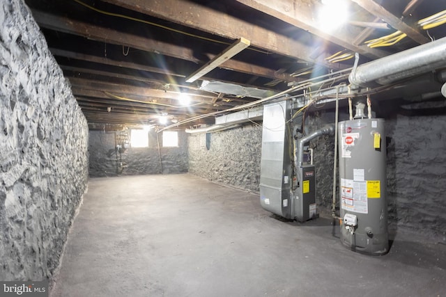 basement featuring gas water heater and heating unit