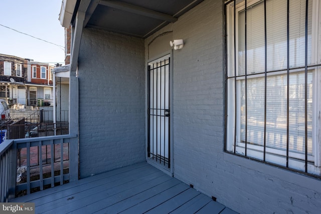 view of exterior entry featuring brick siding