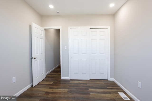 unfurnished bedroom with dark wood-type flooring, recessed lighting, and baseboards