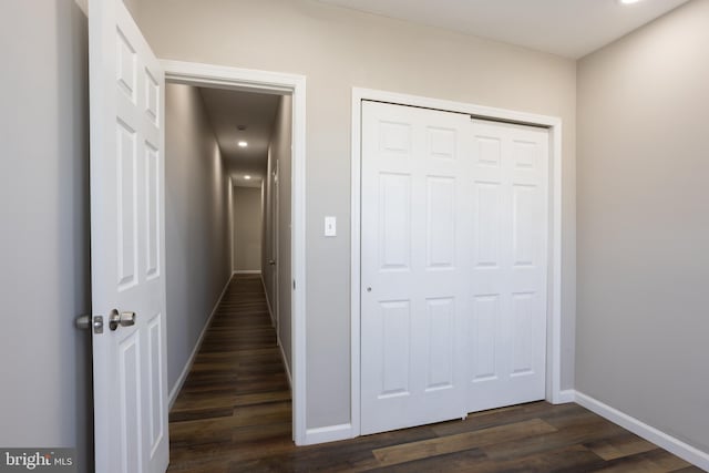 hall with baseboards and dark wood-style flooring