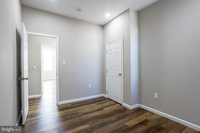 unfurnished bedroom featuring dark wood finished floors, recessed lighting, and baseboards