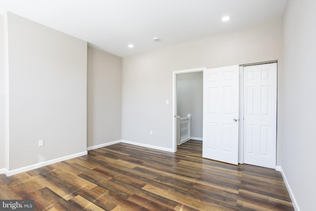 unfurnished bedroom with recessed lighting, baseboards, and dark wood-style flooring