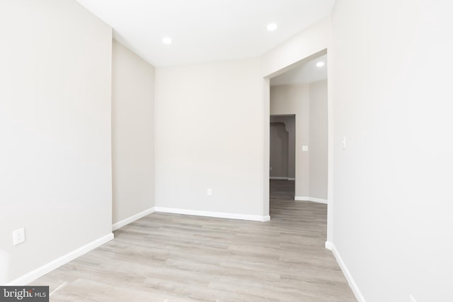 spare room with recessed lighting, light wood-type flooring, and baseboards