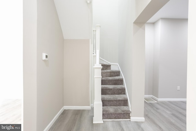 stairs with baseboards and wood finished floors