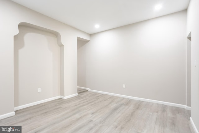 basement featuring recessed lighting, baseboards, and light wood finished floors