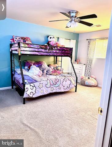 bedroom with baseboards, a ceiling fan, and carpet