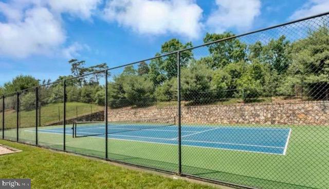 view of sport court featuring fence