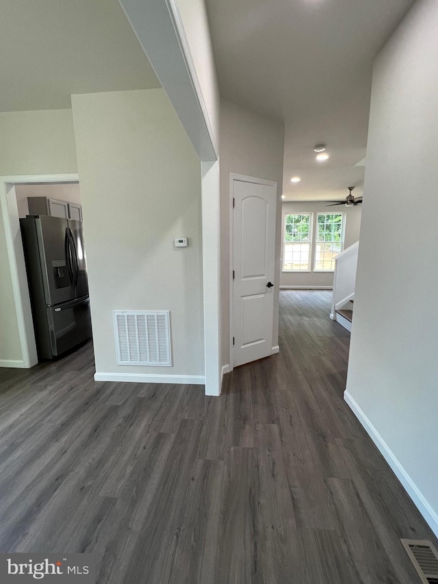 interior space with visible vents, baseboards, and dark wood-type flooring