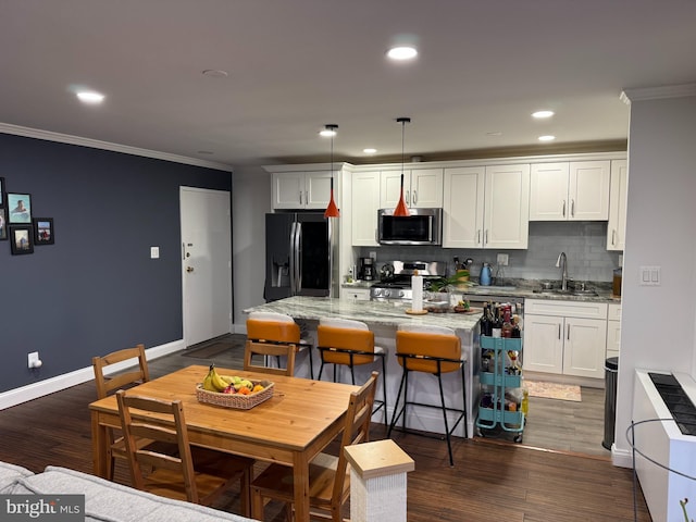 kitchen with stainless steel microwave, black fridge with ice dispenser, crown molding, and range