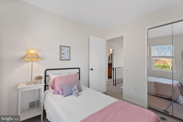 bedroom with visible vents, baseboards, a closet, and carpet floors