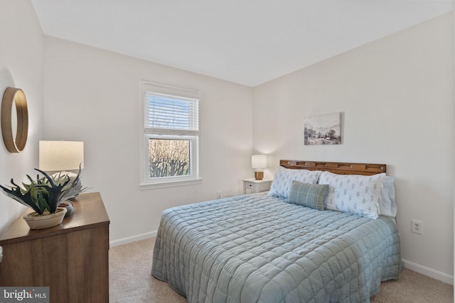 bedroom with carpet flooring and baseboards