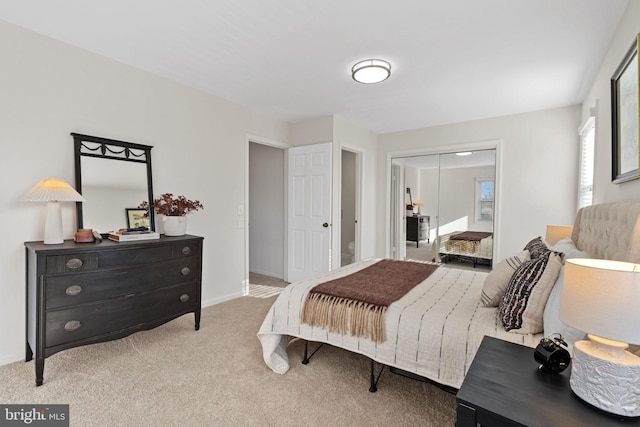 carpeted bedroom with baseboards and a closet