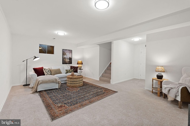 carpeted living room featuring stairs and baseboards