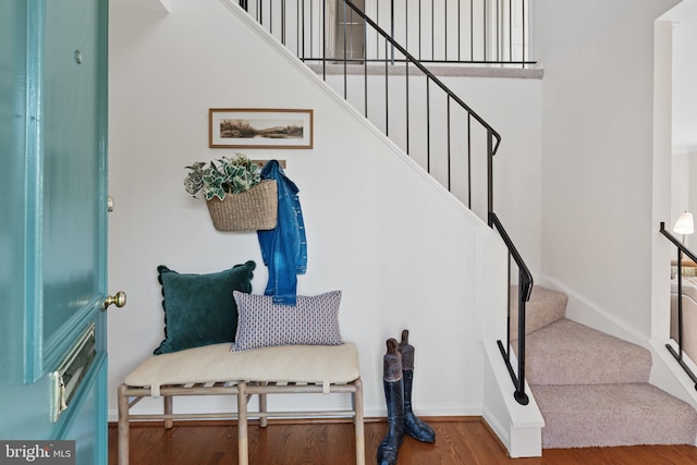 interior space featuring baseboards and wood finished floors