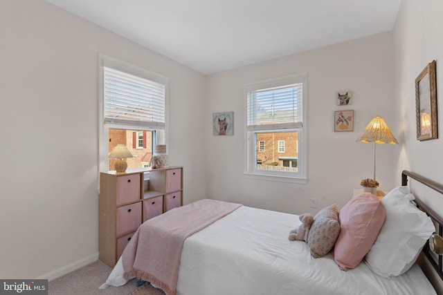 carpeted bedroom featuring baseboards