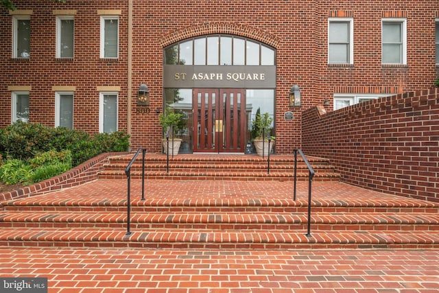 property entrance featuring brick siding