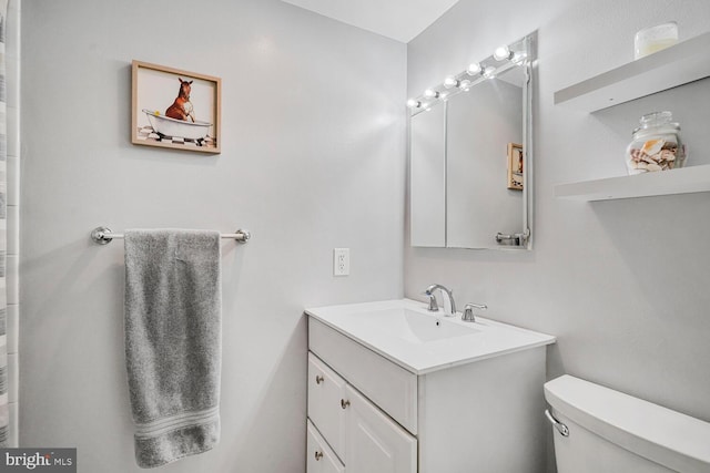 full bathroom with toilet and vanity