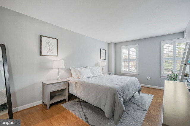 bedroom featuring baseboards and wood finished floors