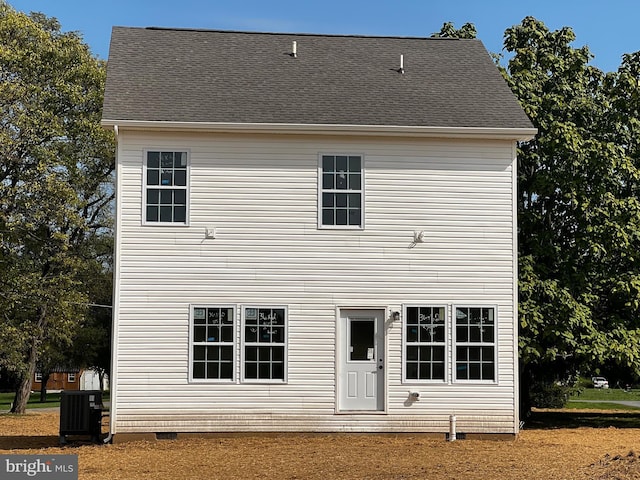 view of front of house featuring central AC unit and roof with shingles