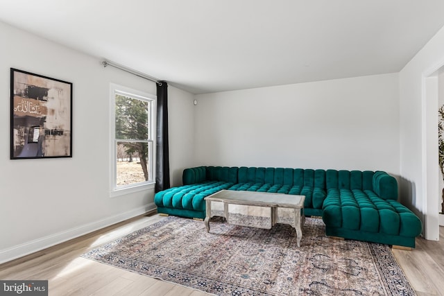 sitting room featuring baseboards and wood finished floors