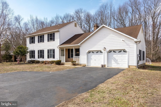 view of front facade featuring an attached garage, roof with shingles, covered porch, a chimney, and driveway