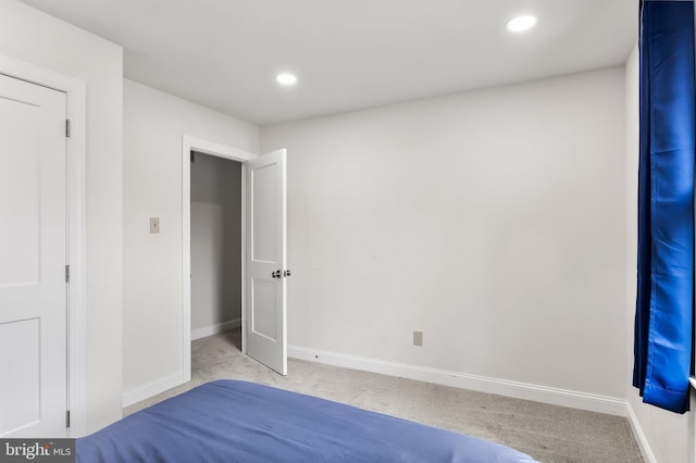 unfurnished bedroom featuring recessed lighting, baseboards, and carpet flooring