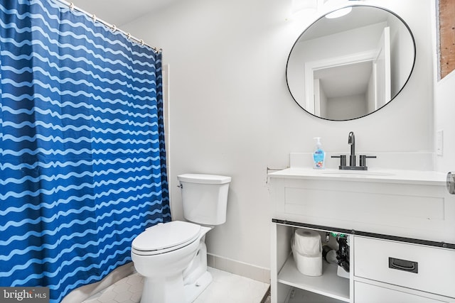 bathroom featuring vanity, toilet, a shower with curtain, and baseboards