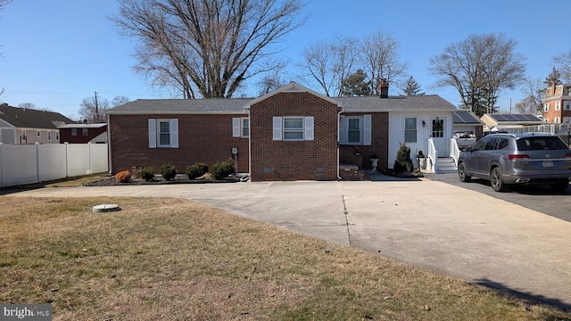 ranch-style house with fence, a front yard, crawl space, brick siding, and a chimney