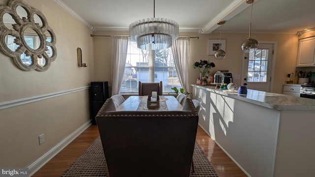 dining space featuring a healthy amount of sunlight, dark wood finished floors, and crown molding