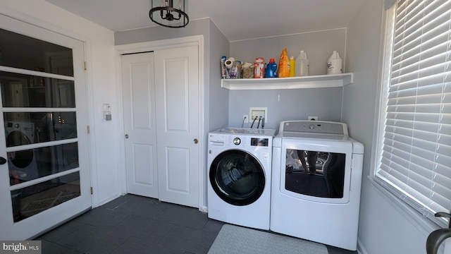 clothes washing area featuring washer and dryer and laundry area