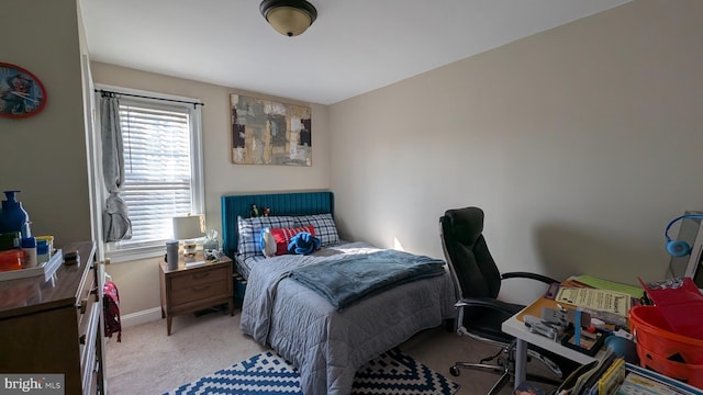 carpeted bedroom featuring baseboards