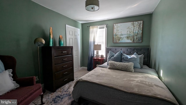 carpeted bedroom featuring baseboards