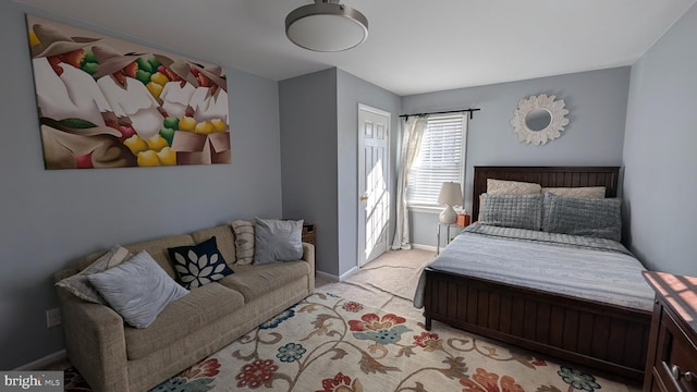 bedroom featuring baseboards and light colored carpet