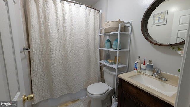 bathroom with vanity, toilet, shower / bath combo, and tile patterned flooring