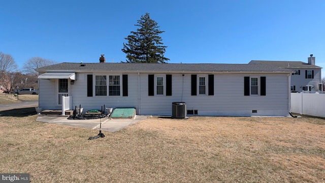 ranch-style house featuring crawl space, a chimney, a front lawn, and fence