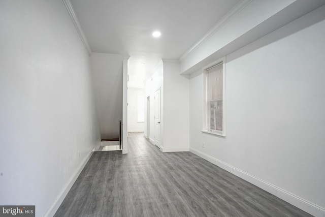 unfurnished room with dark wood-type flooring, baseboards, and ornamental molding