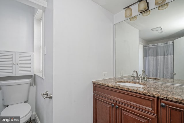 full bath featuring vanity and toilet