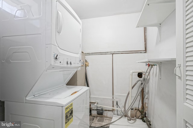 laundry area featuring stacked washing maching and dryer