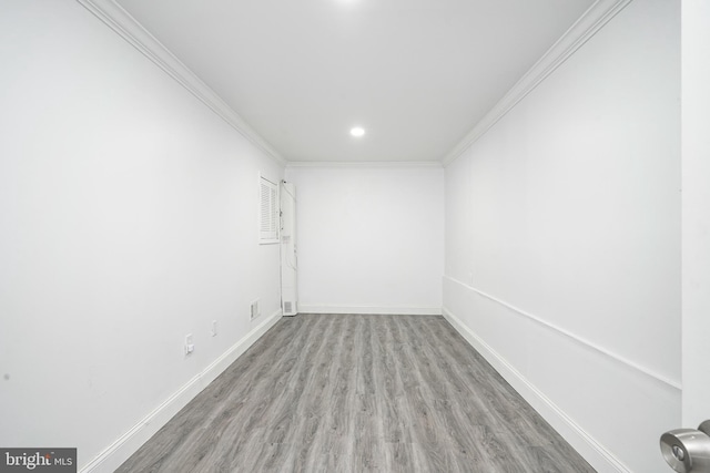 empty room with visible vents, crown molding, baseboards, recessed lighting, and wood finished floors