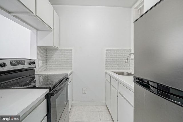 kitchen featuring light tile patterned floors, stainless steel appliances, tasteful backsplash, and a sink