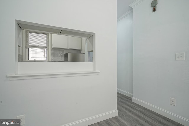 unfurnished room featuring baseboards and wood finished floors