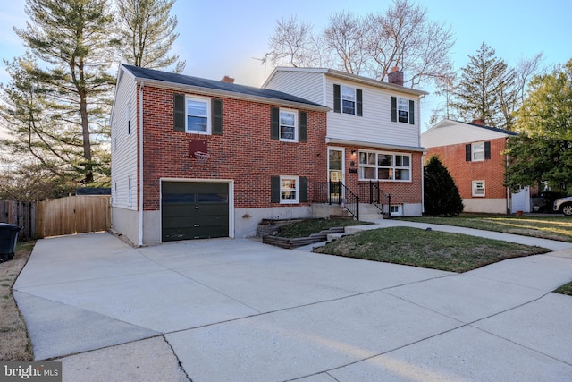 tri-level home featuring fence, concrete driveway, a garage, brick siding, and a chimney