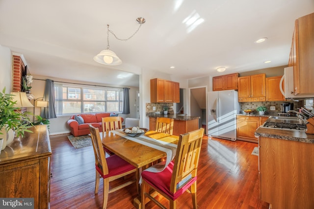 dining space featuring recessed lighting and wood finished floors