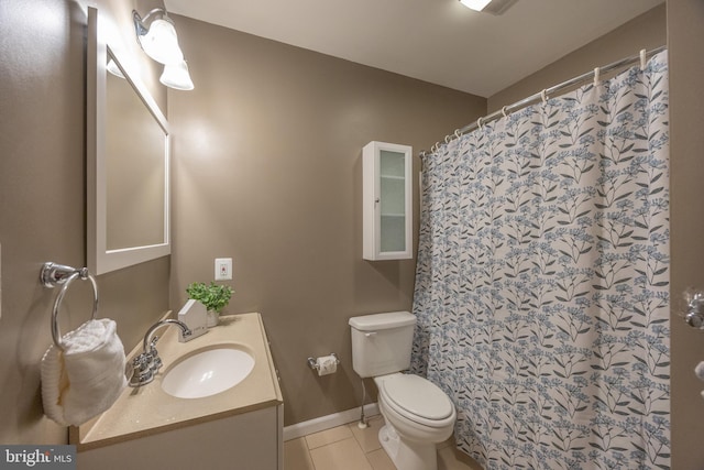 bathroom featuring vanity, a shower with shower curtain, baseboards, tile patterned flooring, and toilet