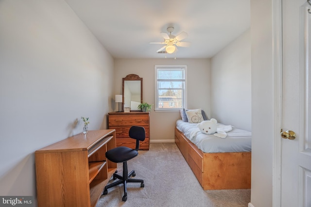 bedroom with light carpet and baseboards