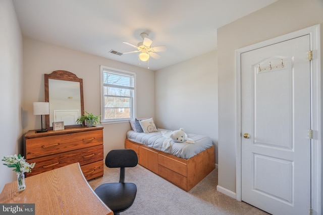 bedroom with visible vents, carpet flooring, and a ceiling fan